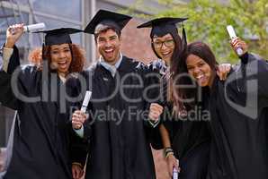 Ecstatic education success. Shot of excited university students on graduation day.
