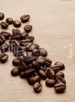 Theres no such thing as too much coffee. Still life shot of coffee beans on a wooden countertop.