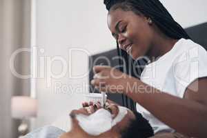 Detoxified skin is a DIY facial away. Shot of a young couple getting homemade facials together at home.