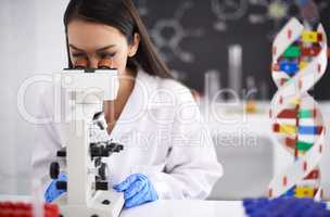The next stage of human evolution. Profile of a female scientist viewing a sample through a microscope.