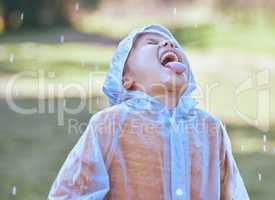 Like water from the heavens. Shot of a little girl sticking her tongue out to catch the rain drops in her mouth.