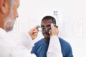 Making people see clearly. Cropped shot of an optometrist testing a patients eyesight.