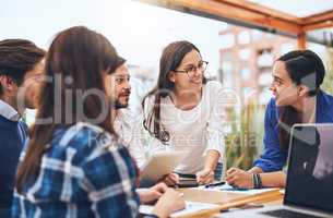 Okay lets go with that. Shot of a group young creative businesspeople working together around a table outside of a coffeeshop.