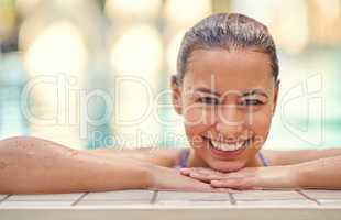 Youre only one swim away from a good mood. Shot of a young woman relaxing in the pool at a spa.