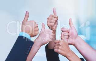 Well done. Shot of a group of office workers showing thumbs up together.