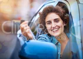 Life is a journey and you hold the keys. Shot of a happy young woman holding the keys to a new car.