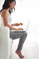 If theres a bargain somewhere, shell find out. Shot of a young woman using her credit card to make a purchase online.
