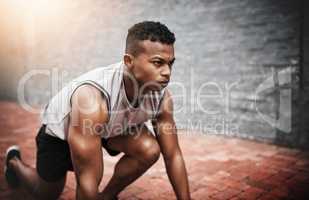 Your training is never for nothing. Shot of a sporty young man exercising outdoors.