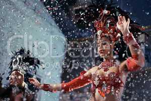 Fiery festival dancers. Shot of two beautiful samba dancers performing in a carnival.