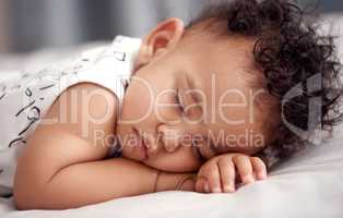 Sleep well little one. Shot of an adorable baby boy sleeping peacefully on the bed at home.