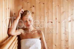 This is her bliss. A gorgeous blond woman relaxing in a sauna.