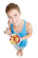 Eat healthy and be happy. Studio portrait of a young woman enjoying a muesli and yoghurt treat.