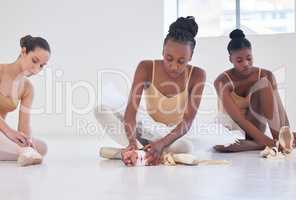 Well have our break on the floor. Shot of a group of young ballerinas preparing for rehearsal.