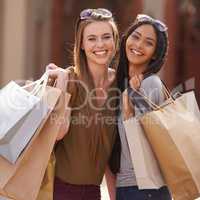 A successful day of shopping. A portrait of two smiling young ladies with their shopping bags.