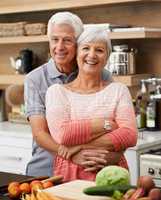 Id do anything for her, even learn to cook. Shot of an attractive senior couple posing affectionately in a kitchen.
