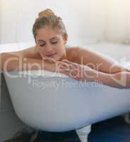 The best way to unwind after a long week. Shot of beautiful young woman relaxing in the bathtub.