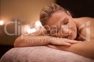 Basking in the afterglow of her massage. Cropped shot of a woman in a day spa relaxing on a massage table.