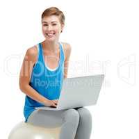 Why suffer from back pain, surf in comfort. Shot of a young woman using a laptop while sitting on a exercise ball.