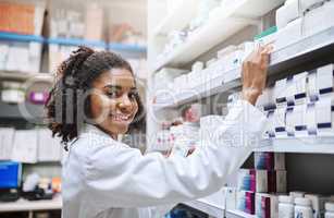 Making sure the inventory is neat and easy to find. Cropped portrait of an attractive young female pharmacist working in a pharmacy.