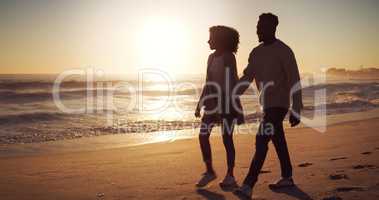 Side by side together on every walk of life. Full length shot of an affectionate young couple taking a stroll on the beach at sunset.