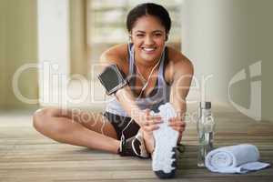 Getting active is a valuable way to improve your happiness. Portrait of a sporty young woman warming up before a run.