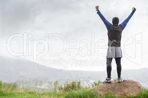Ive made it to the top. A young man celebrating at the top of a mountain after reachin.