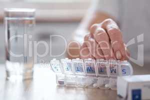 Too much poison come undone. Cropped shot of an unrecognizable elderly man arranging his medication at the table at home.