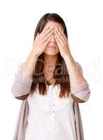 See no evil. Casually dressed young woman with her hands covering her eyes.