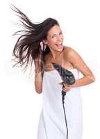 Blowing in the wind... of the hair dryer. An attractive woman expressing enjoyment while drying her hair.