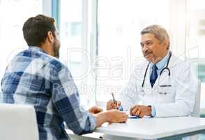 Rest assured your results are looking good. Shot of a confident mature male doctor consulting with a patient inside of his office during the day.