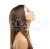 Long, silky and smooth. A lovely young woman with luxurious hair isolated on a white background.