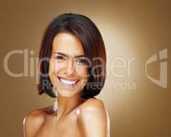 Naked young woman smiling against colored background. Closeup portrait of a naked young woman smiling against colored background.