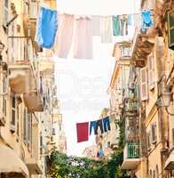 Its a different way of life. Low angle shot of clothing hanging from clothing lines between buildings in a foreign city.