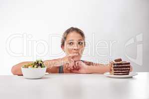 Shes a lover of chocolate. Studio shot of an attractive young woman being tempted by something sweet.