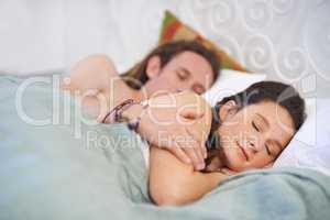 Even in sleep they show affection. A young couple sleeping in each others arms.