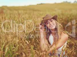 Out here is where I belong. Cropped shot of a young woman in a wheat field.
