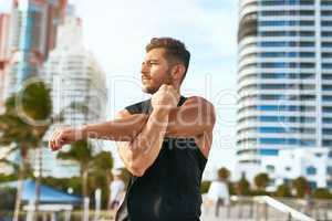 Keeping both his mindset and body strong. Shot of a handsome young man exercising outdoors.