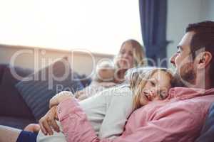 Love them, nurture them, care for them. Shot of an adorable young family of four relaxing together on the sofa at home.