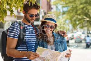 Where to next, my love. Shot of a happy tourist couple using a map to explore a foreign city together.