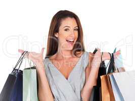 I dont think I bought enough. Portrait of a young woman carrying shopping bags isolated on white.