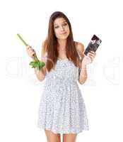 What would you do. An attractive young woman deciding between a stick of celery and a slab of chocolate.