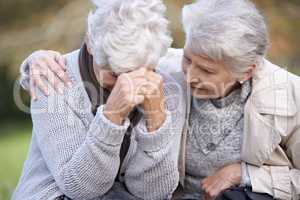 We are always there for each other. A senior woman consoling her friend as they sit outdoors.
