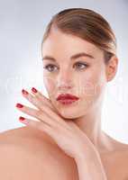 Highlighting her most beautiful features. Portrait of an attractive young woman wearing bright red lipstick and nail polish.