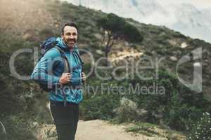 Lets journey to the centre of the world. Portrait of a middle aged man hiking in the mountains.