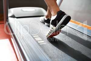 Running to stay fit. Closeup shot of a man on a treadmill at the gym.
