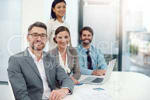 White collar confidence. Portrait of a group of businesspeople working together in a modern office.