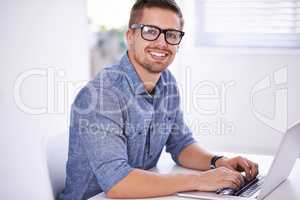 Modern business Fast-paced, innovative and online. A young creative businessman using his laptop.