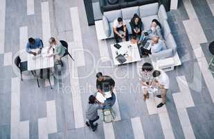Hard work yields the highest rewards. High angle shot of a group of businesspeople having a meeting at a conference.