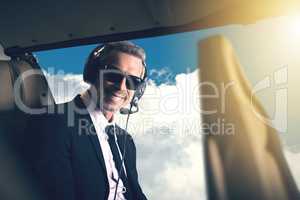 Because who has time to sit in traffic. Portrait of a mature businessman traveling in a helicopter.
