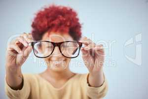 Look at life from my perspective. Studio shot of a a woman showing off her spectacles.